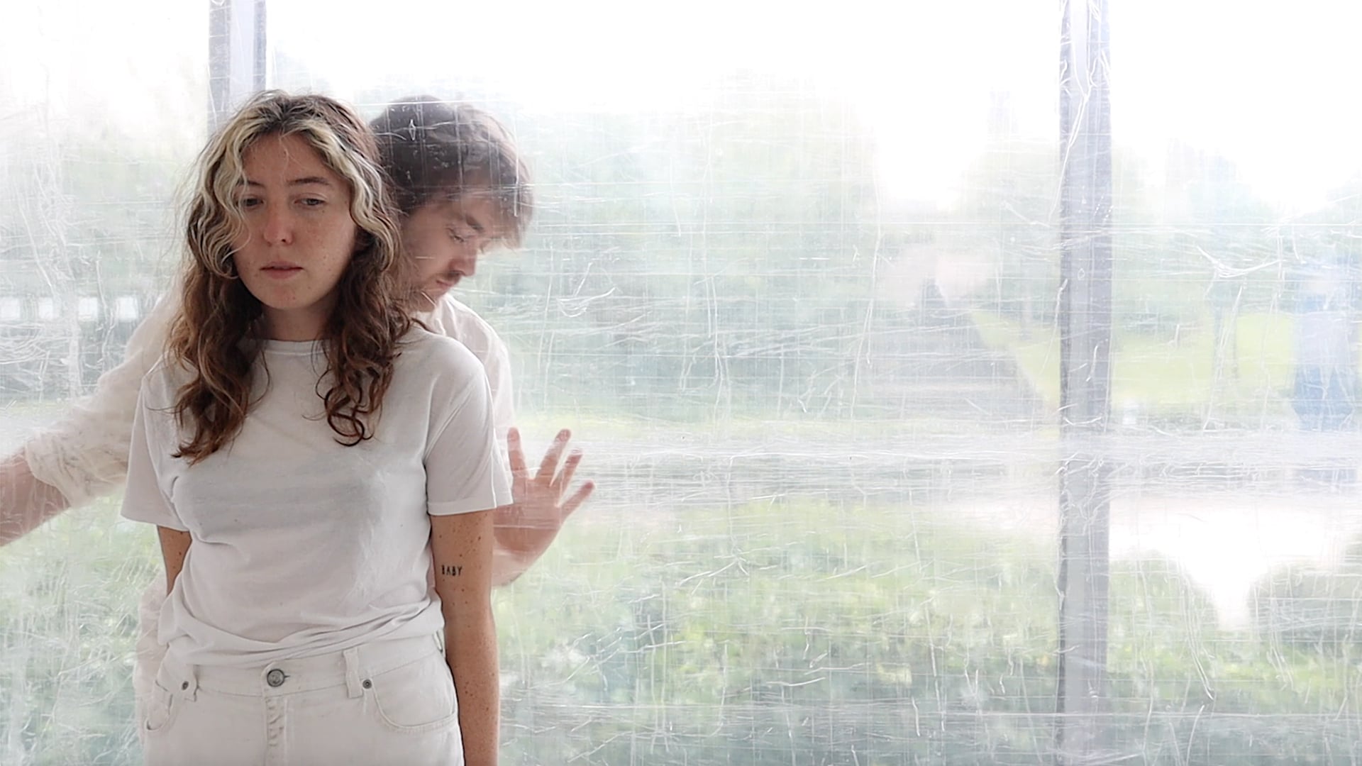 Cos Ahmet, A Meniscus Between, 2021 - Still from digital video. Performers, choreographic object, clear tape.